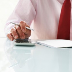 Businessman Using Calculator